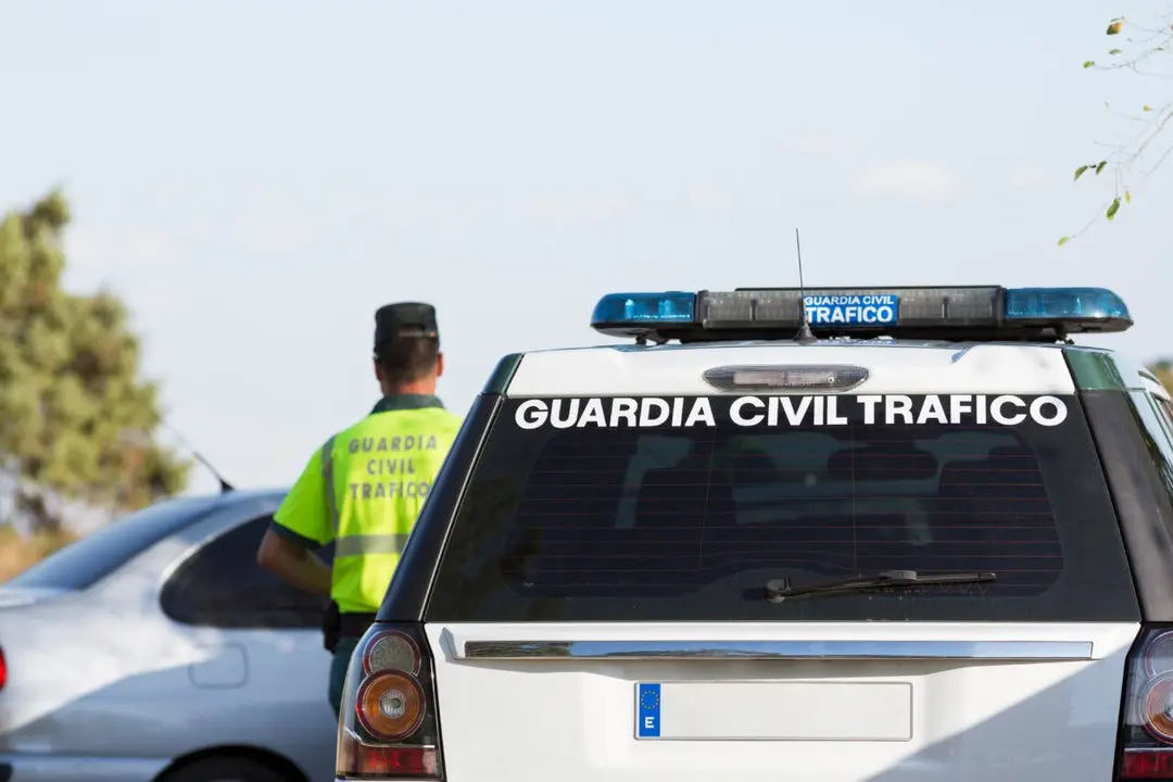 Agent of the civil traffic police with his patrol car in Madrid, Spain.