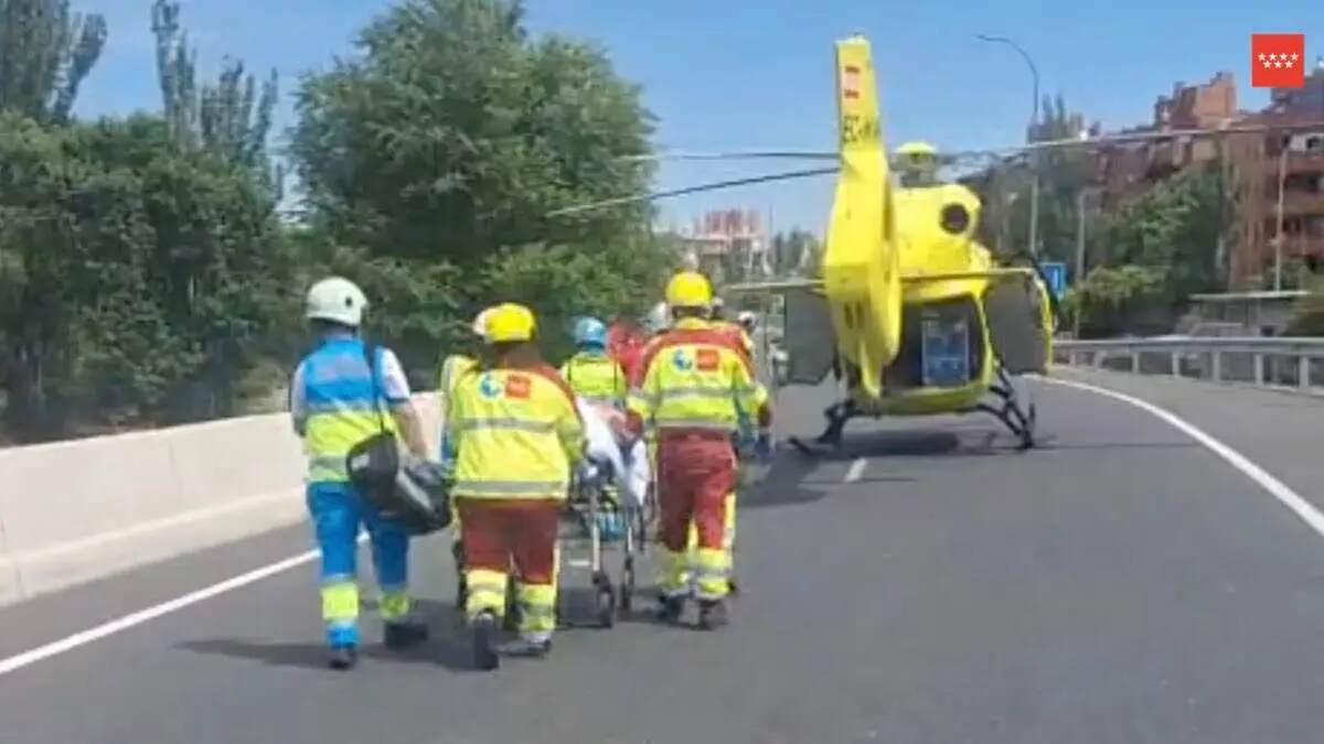 Sanitarios del SUMMA trasladan al motorista herido hasta el helic&oacute;ptero sanitario. 112 COMUNIDAD DE MADRID
