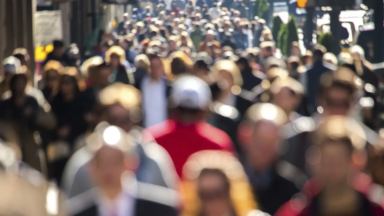 Anonymous crowd of people walking street