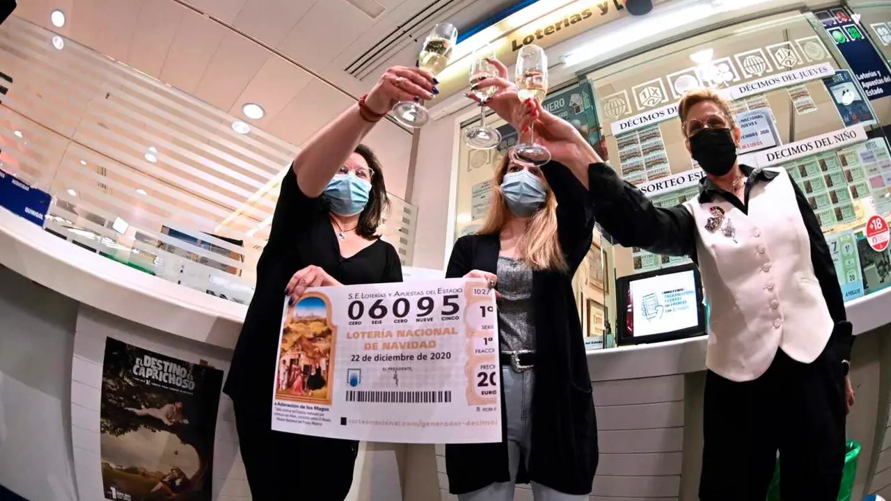 GRAF279. MADRID, 22/12/2020.- En la administraci&oacute;n de Loter&iacute;a del C.C.Hipercor de Alcal&aacute; de Henares celebran haber vendido d&eacute;cimos del n&uacute;mero 6095 agraciado con el segundo premio en el Sorteo Extraordinario de la Loter&iacute;a de Navidad que se celebr&oacute; este martes en el Teatro Real de Madrid. EFE/Fernando Villar