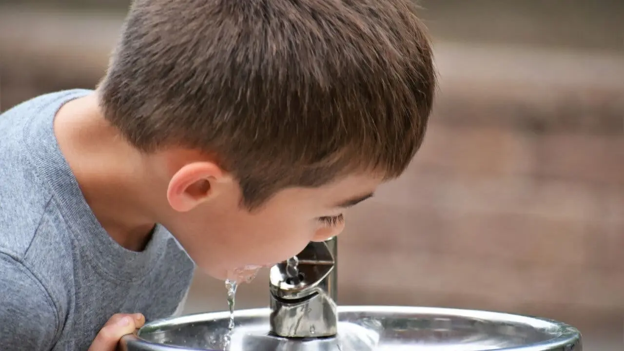 close up, Boy drinking water from a water fountain.