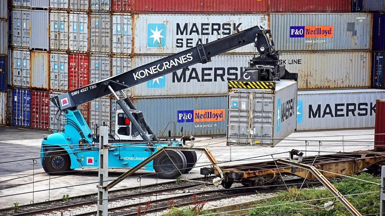 AZUQUECA DE HENARES, SPAIN - AUGUST 28, 2017: Man working with elevator vehicle for goods transport containers
