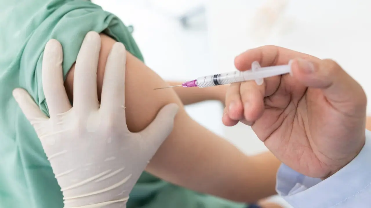 Close up of a Doctor making a vaccination in the shoulder of patient, Flu Vaccination Injection on Arm, coronavirus, covid-19 vaccine disease preparing for human clinical trials vaccination shot.