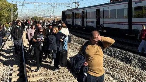 Pasajeros evacuando tras el descarrilamiento de un tren en San Fernando de Henares