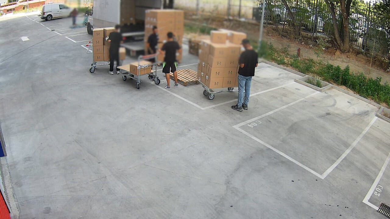 Grupo de personas manipulando cajas en un área de carga